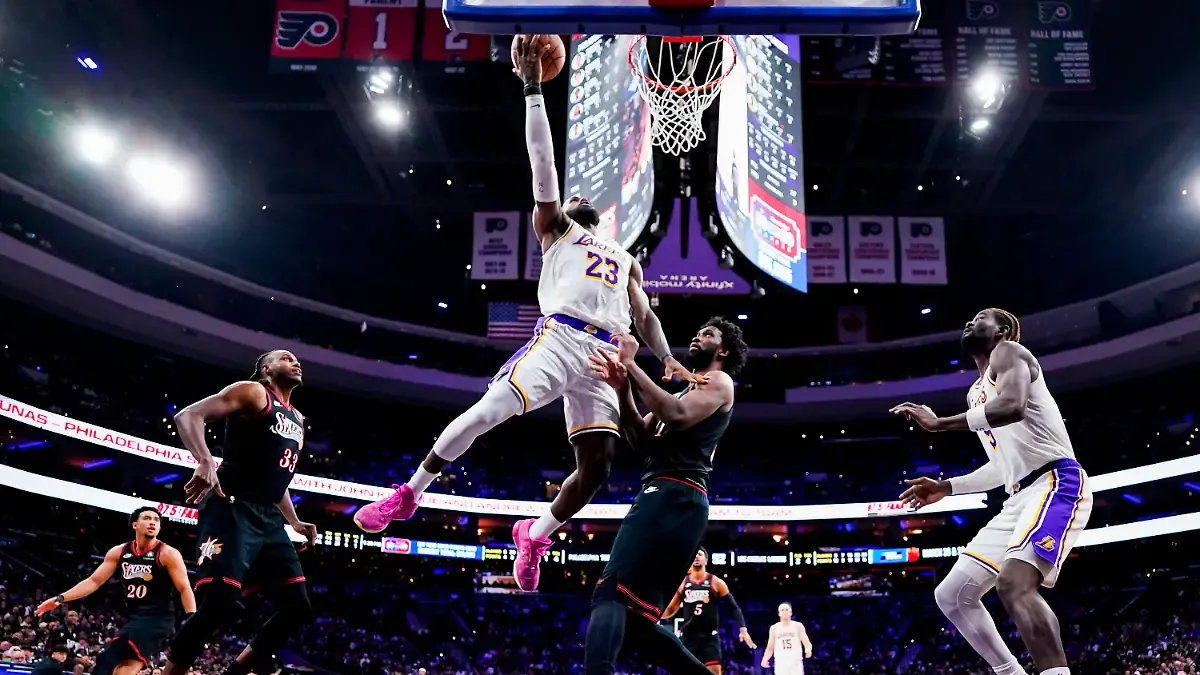 FILE-Los-Angeles-Lakers-LeBron-James-center-left-goes-up-for-the-shot-against-Philadelphia-76ers-Joel-Embiid-center-right-during-the-second-half-of-an-NBA-basketball-game-Dec-7-2025-in-Philadelphia